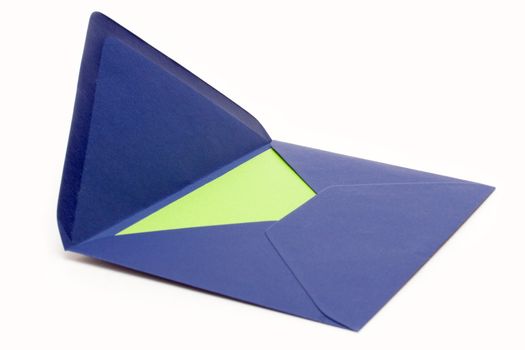 Green paper in an open blue envelope. Isolated on a white background.