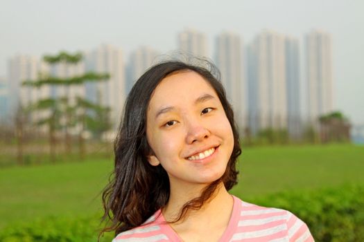 Portrait of young Asian woman outdoors. Shallow DOF. 