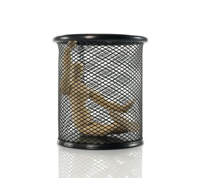 wooden puppet sitting in black metal bin