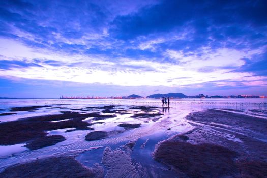 Sunset in Hong Kong along sea shore at dusk