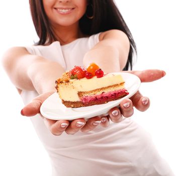 Piece of cake on a plate in woman hands