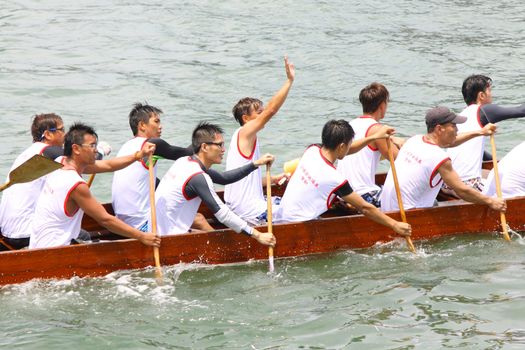 HONG KONG - JUN 6: Athletes fight hard for victory and they won at the dragon boat racing in Tuen Ng Festival 6; June 2011 in Tuen Mun; Hong Kong.