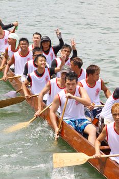 HONG KONG - JUN 6: Athletes fight hard for victory and they won at the dragon boat racing in Tuen Ng Festival 6, June 2011 in Tuen Mun, Hong Kong.