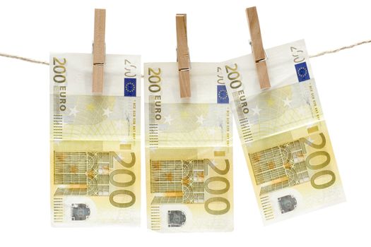 Three two hundred euro bills hanging on a clothesline. Isolated on a white background.