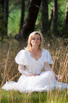 gorgeous bride posing in forest