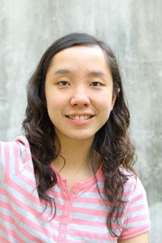 Portrait of young Asian woman outdoors. Shallow DOF.