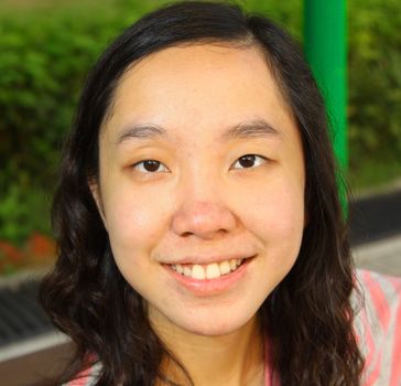 Portrait of young Asian woman outdoors. Shallow DOF.