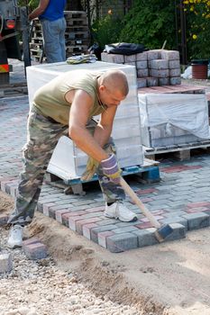 Worker on job. Constructing a new street