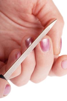 Woman polishing using nailfile her fingernails