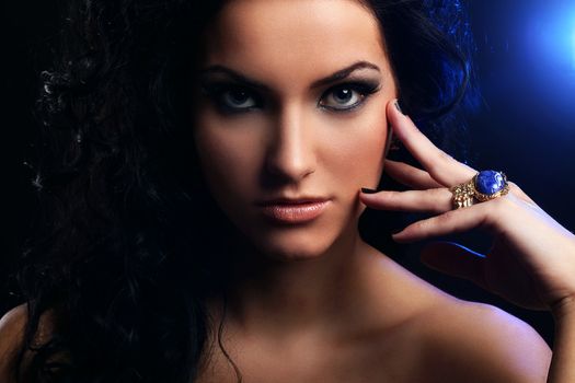 Beautiful brunette with curls evening makeup