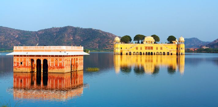 The palace Jal Mahal at night.  Jal Mahal (Water Palace) was built during the 18th century in the middle of Mansarovar Lake.  Jaipur, Rajasthan, India, Asia. Panorama.