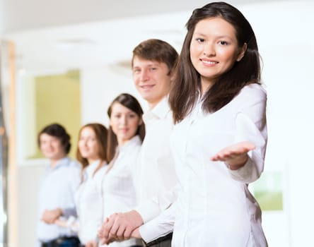 group of people holding hands, woman holds out her hand, the concept of teamwork