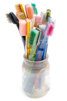 Old toothbrushes used for creative artwork. Isolated on white background.