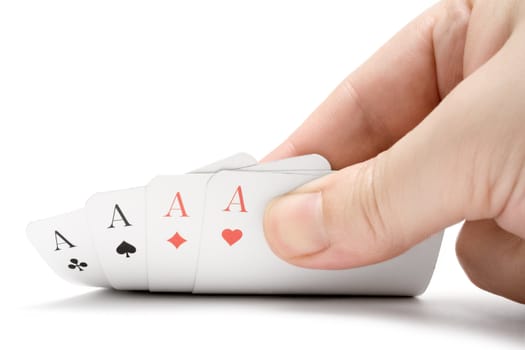 Fingers holding four aces. Isolated on a white background.