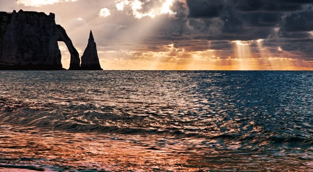 Colourful sunset at Etretat in the Upper Normandy in the North of France.The rocks formation is called L'Aiguille.