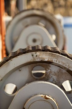 Cogwheels and chains with rust on rig station