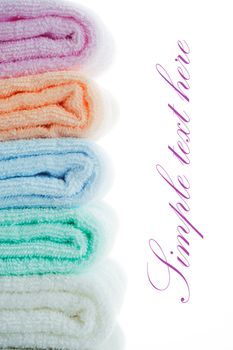 multicolor towels stacked on white background with area for your text