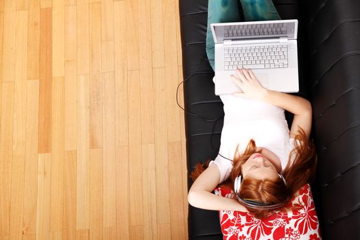 A young woman surfing on the Internet with a Laptop.  