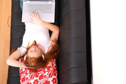 A young woman surfing on the Internet with a Laptop.  