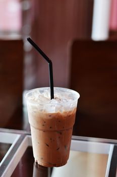 Cold coffee drink with ice on a  table