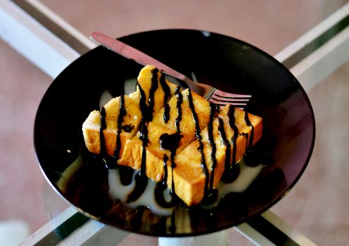 Toast topped with sweetened condensed milk and chocolate sauce