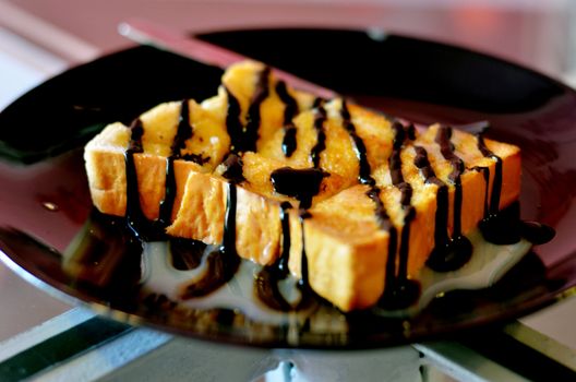 Toast topped with sweetened condensed milk and chocolate sauce