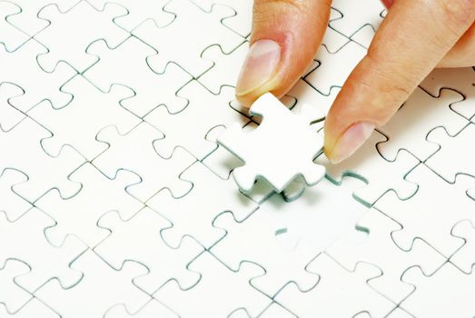 hands holding a puzzle piece . business concepts