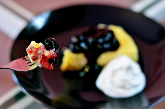 close-up of blueberry cheese cake on fork