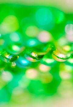 Green beads on the mirror with shallow DOF in portrait orientation
