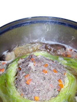 Minced pork mixed with flavouring stuffed in cabbage boiling in soup in pot, traditional Thai style food.