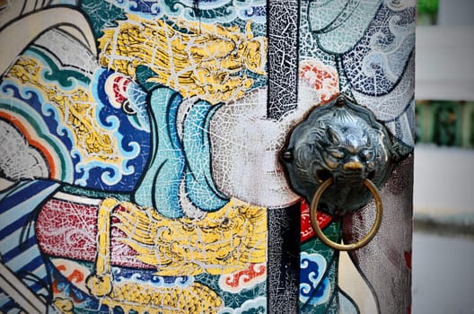 Ancient lion door handle with nice old Chinese art painted, Bangkok, Thailand