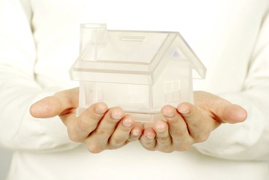 The house in human hands on white