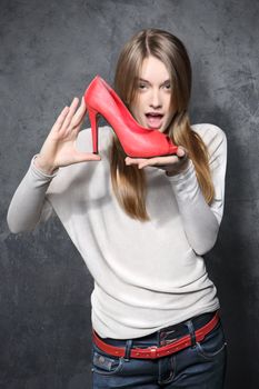 Girl holding a red shoe