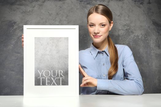 Young woman displaying a banner add isolated over a white background