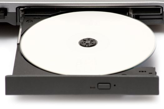 Blank CD in a notebook drive. White background.
