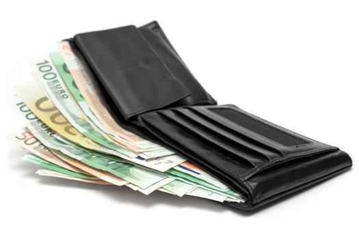 Open leather wallet with banknotes isolated on a white background.