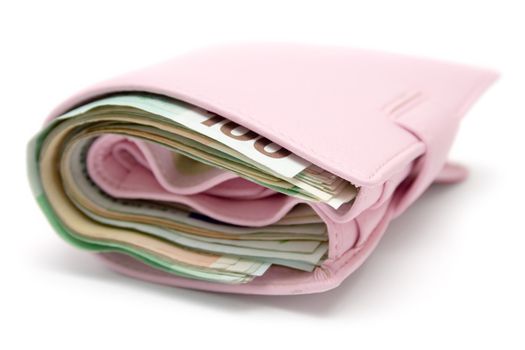 Feminine leather wallet full of banknotes. Isolated on a white background.