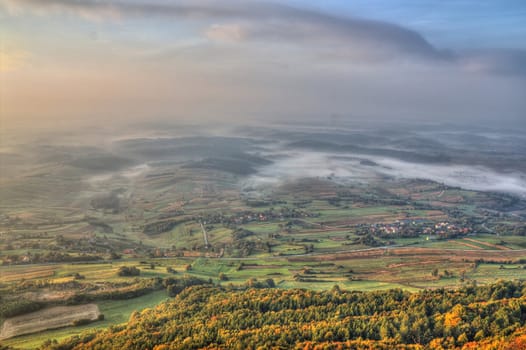 View from Kalnik mountain - fog in the valley, beautiful green landscape