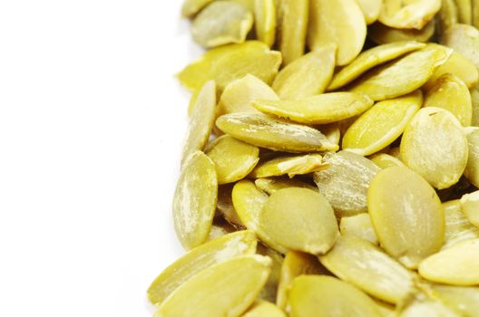 fresh pumpkin seeds isolated on a white
