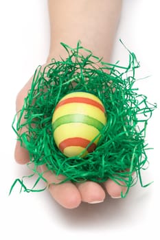 Female hand holding an Easter egg. Isolated on a white background.