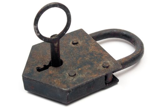 Antique rusty padlock with key. Isolated on white.