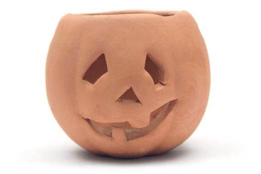 Self-made clay pumpkin isolated on white.