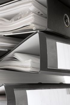 Stack of file folders full of documents.