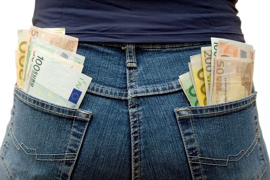 Blue jeans stuffed with Euro banknotes. White background.