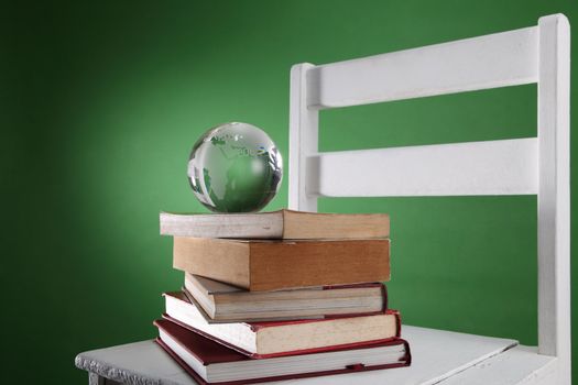 glass globe on top of stack of book