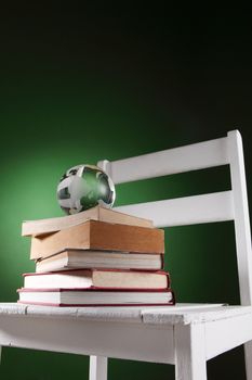 glass globe on top of stack of book