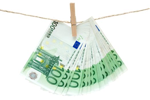 Several one hundred euro bills held by a clothesline. Isolated on a white background.