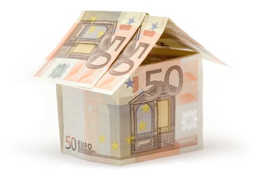 Small cottage build of fifty euro bills. Isolated on a white background.
