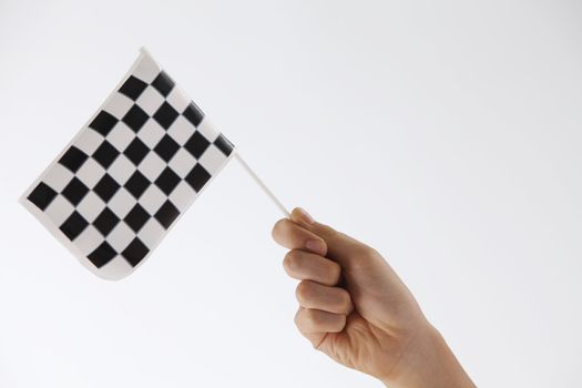 hand holding a mini checker flag