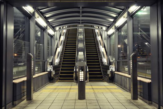 symmetrical interior with modern escalators at night time, Tokyo Japan